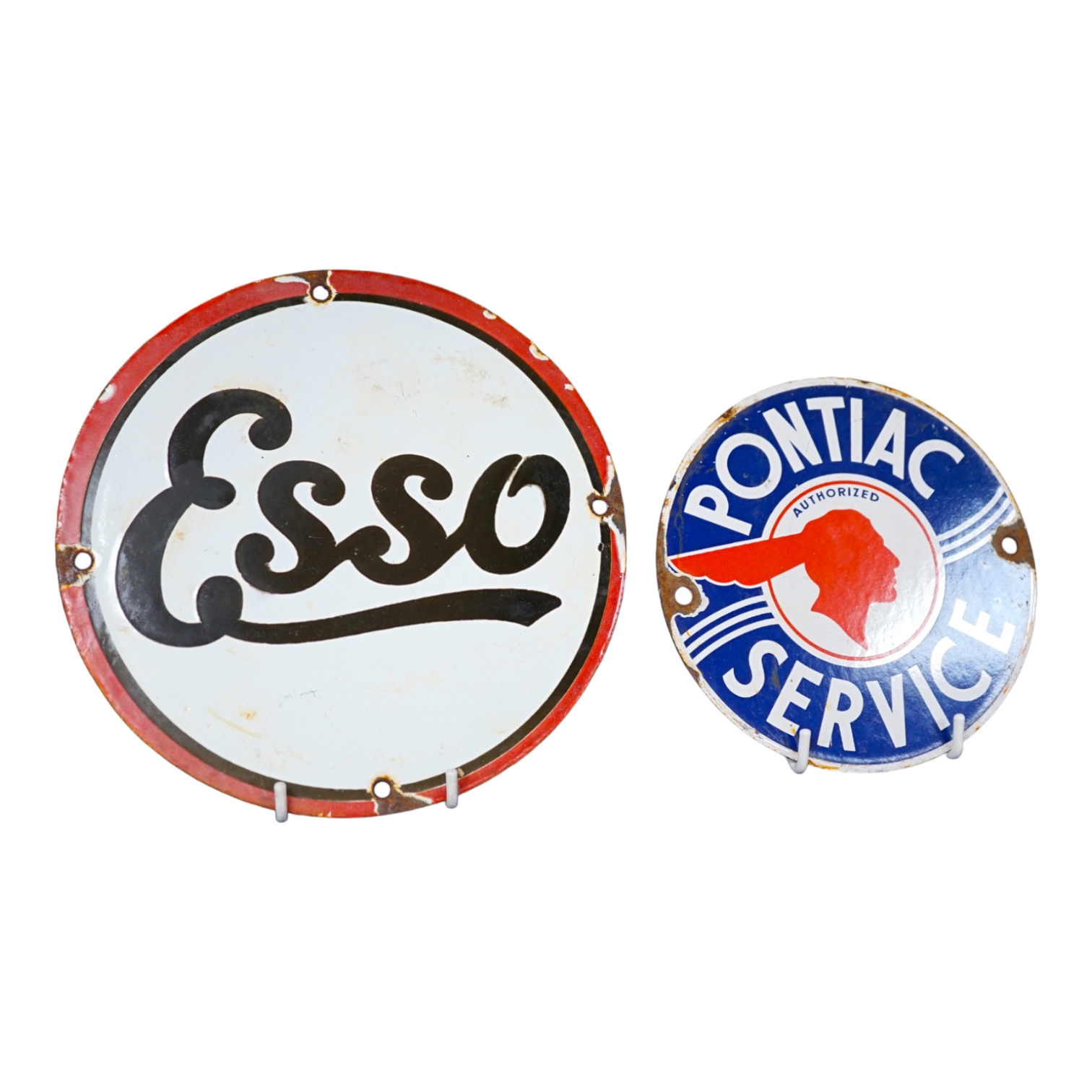 Automobilia interest; an early 20th century Esso enamel sign, diameter 20cm, and a Pontiac Service enamel sign, diameter 15cm. Condition fair to good, some chipping around the screw holes and surface rust to exposed meta